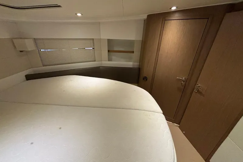 Slide: The Image of Interior cabin of 2014 Beneteau Gran Turismo 49 yacht, featuring a cozy bed and wooden decor. - 45