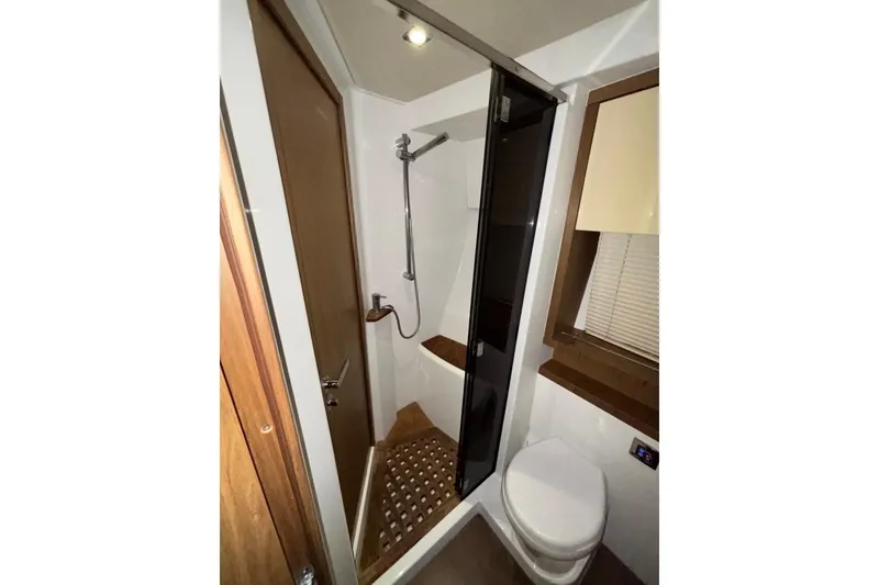 Slide: The Image of Bathroom interior of 2014 Beneteau Gran Turismo 49 yacht, featuring shower and toilet. - 49