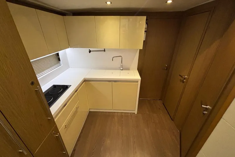 Slide: The Image of Modern kitchen interior on a 2014 Beneteau Gran Turismo 49 yacht, featuring sleek cabinetry and appliances. - 51