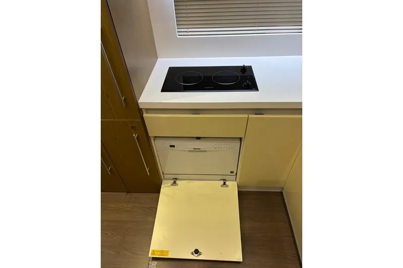 Slide: The Image of Modern kitchen in 2014 Beneteau Gran Turismo 49 yacht with stove and dishwasher. - 52