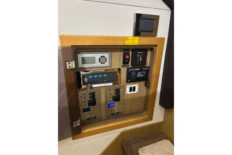 Slide: The Image of Control panel of a 2014 Beneteau Gran Turismo 49 yacht, featuring various switches and displays. - 54