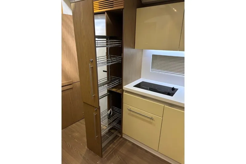 Slide: The Image of Modern kitchen in 2014 Beneteau Gran Turismo 49 yacht with pull-out pantry and stovetop. - 56