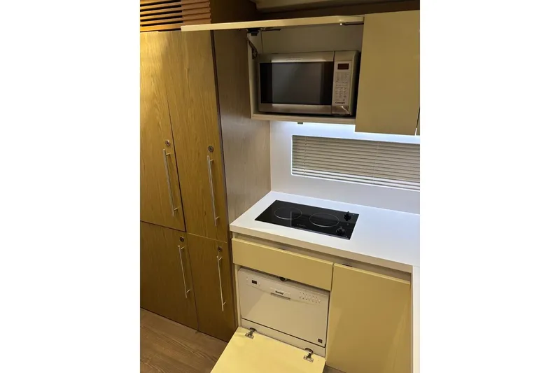 Slide: The Image of Modern kitchen in 2014 Beneteau Gran Turismo 49 yacht with microwave, stovetop, and dishwasher. - 57