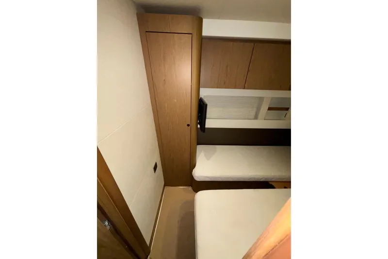 Slide: The Image of Interior cabin of 2014 Beneteau Gran Turismo 49 yacht with twin beds and wooden cabinetry. - 60