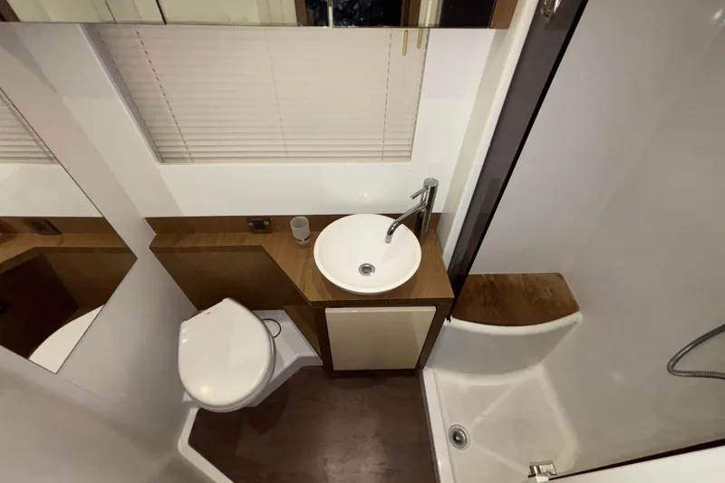 Slide: The Image of Bathroom interior of 2014 Beneteau Gran Turismo 49 yacht, featuring sink, toilet, and shower. - 62