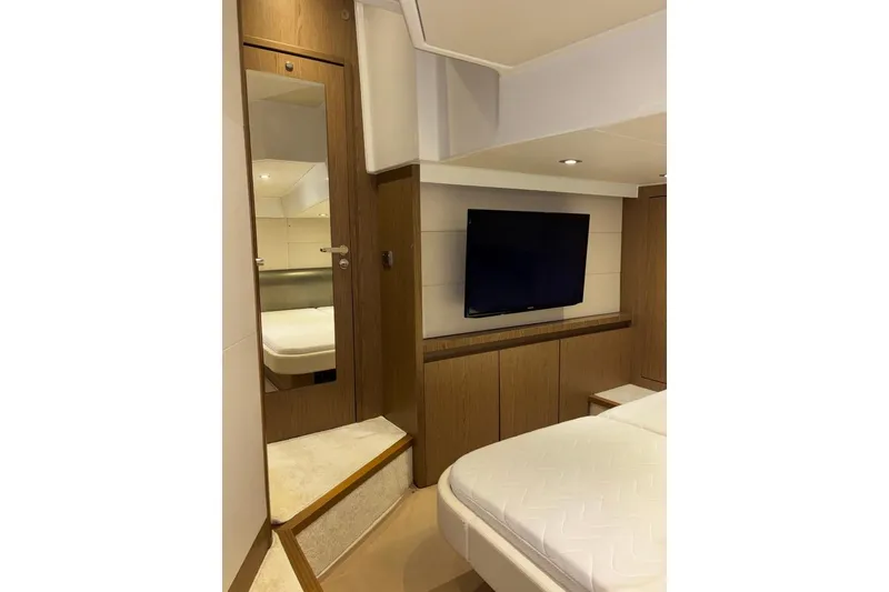 Slide: The Image of Luxurious interior of 2014 Beneteau Gran Turismo 49 yacht with modern TV and elegant wood finish. - 67