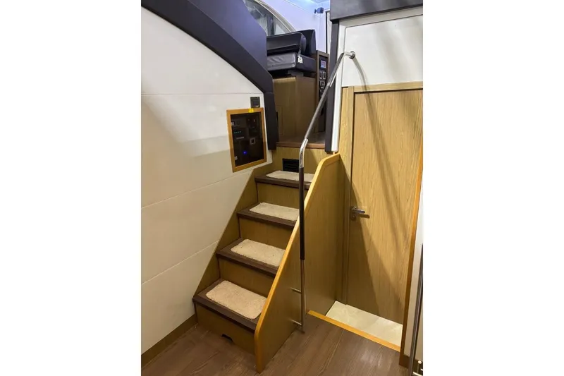Slide: The Image of Staircase inside 2014 Beneteau Gran Turismo 49 yacht, featuring wooden steps and modern design. - 68
