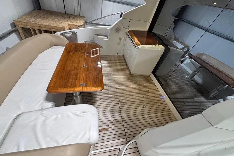 Slide: The Image of 2014 Beneteau Gran Turismo 49 yacht interior with wooden table and seating area. - 7