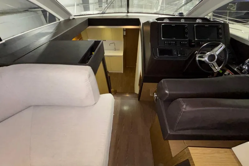 Slide: The Image of Interior of 2014 Beneteau Gran Turismo 49 yacht with helm, seating, and kitchenette. - 70