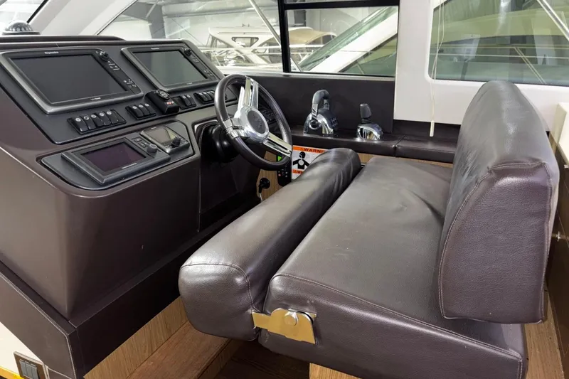 Slide: The Image of Helm station of 2014 Beneteau Gran Turismo 49 with leather seating and navigation controls. - 72