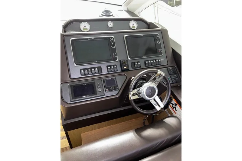 Slide: The Image of Helm of 2014 Beneteau Gran Turismo 49 with dual navigation screens and steering wheel. - 73