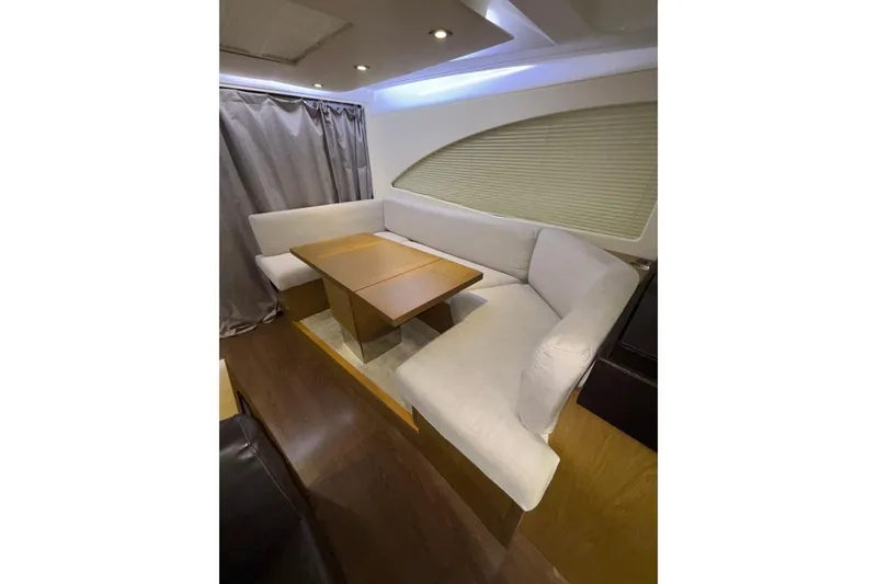 Slide: The Image of Interior of 2014 Beneteau Gran Turismo 49 yacht with cozy seating and wooden table. - 74