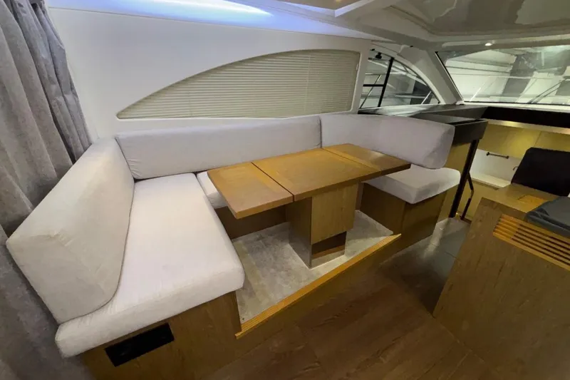Slide: The Image of Interior of 2014 Beneteau Gran Turismo 49 yacht with cozy seating and wooden table. - 75