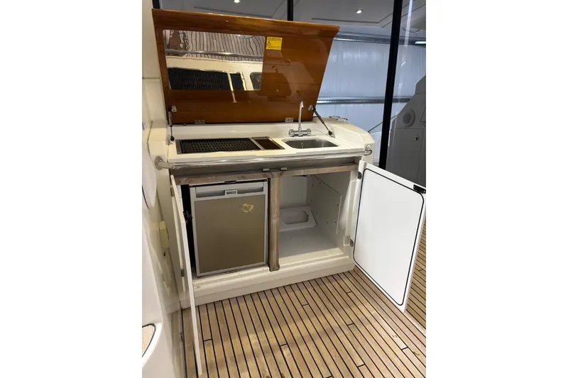 Slide: The Image of 2014 Beneteau Gran Turismo 49 yacht kitchenette with sink, grill, and mini fridge. - 9
