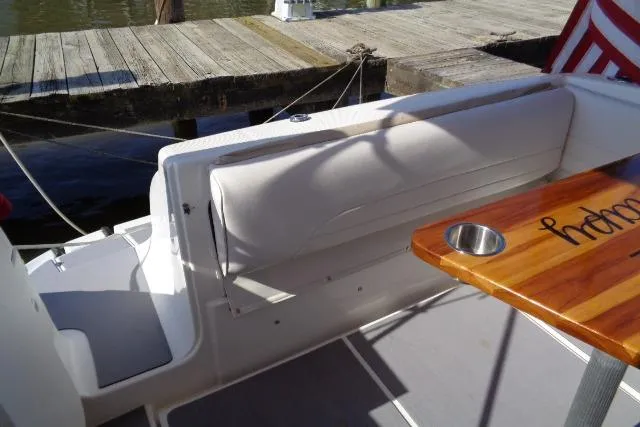 Slide: The Image of 2002 Chaparral Signature 260 boat interior with cushioned seating and wooden table. - 12