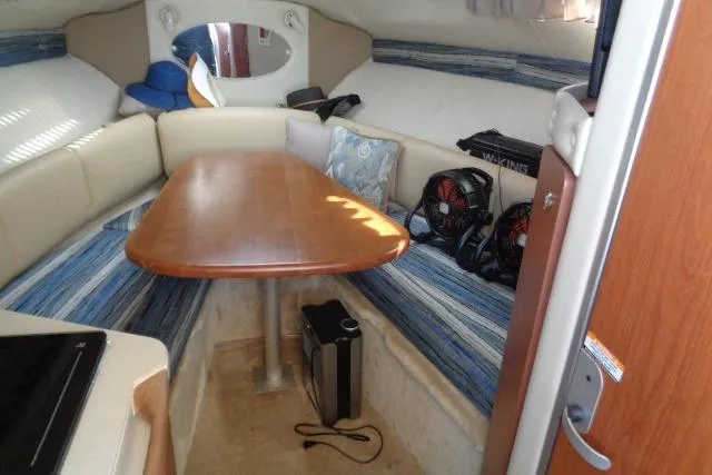 Slide: The Image of 2002 Chaparral Signature 260 cabin interior with seating, table, and accessories. - 15