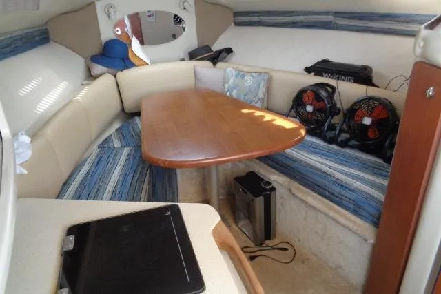 Slide: The Image of Interior of a 2002 Chaparral Signature 260 boat with seating and table. - 16