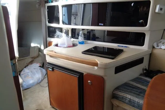 Slide: The Image of Interior of 2002 Chaparral Signature 260 boat with kitchenette and seating area. - 17