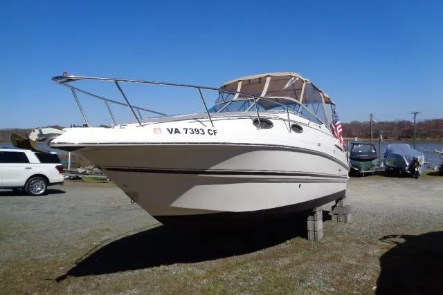 Slide: The Image of 2002 Chaparral Signature 260 boat on land, with clear blue sky background. - 2