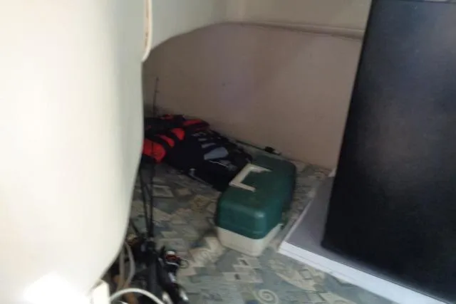 Slide: The Image of Interior of 2002 Chaparral Signature 260 with fishing gear and life jackets. - 21