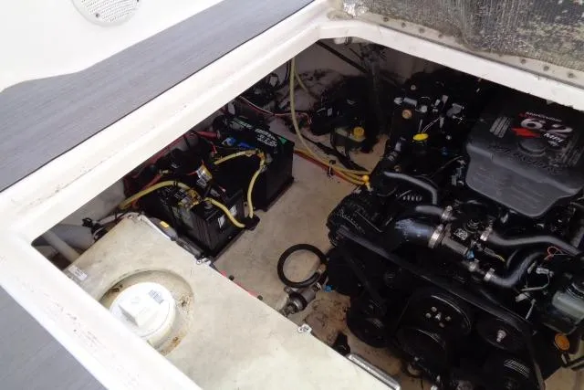 Slide: The Image of Engine compartment of a 2002 Chaparral Signature 260 boat, showing batteries and engine components. - 24