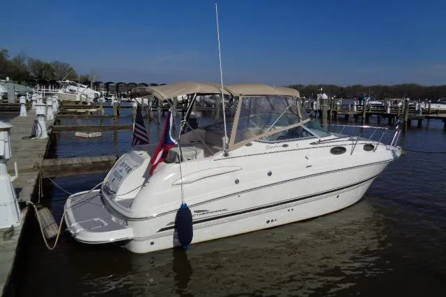Slide: The Image of 2002 Chaparral Signature 260 boat docked at a marina under clear blue skies. - 5