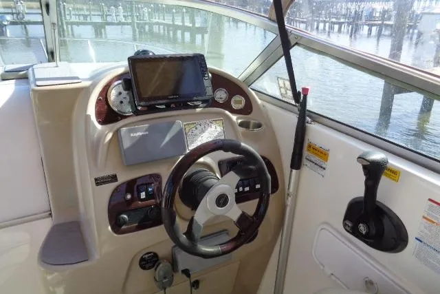 Slide: The Image of 2002 Chaparral Signature 260 boat helm with steering wheel and navigation equipment. - 6