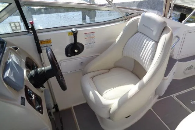 Slide: The Image of 2002 Chaparral Signature 260 boat cockpit with steering wheel and comfortable captain's chair. - 8