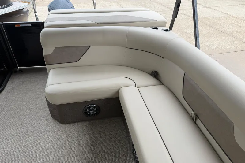 Slide: The Image of 2021 Crest Classic LX 200 L boat interior with beige seating and cup holders. - 13