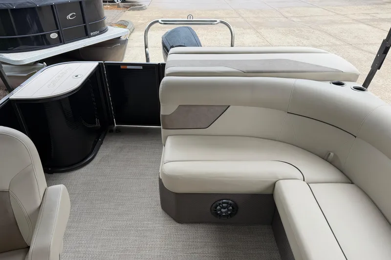 Slide: The Image of Interior of 2021 Crest Classic LX 200 L pontoon boat with beige seating and cup holders. - 14