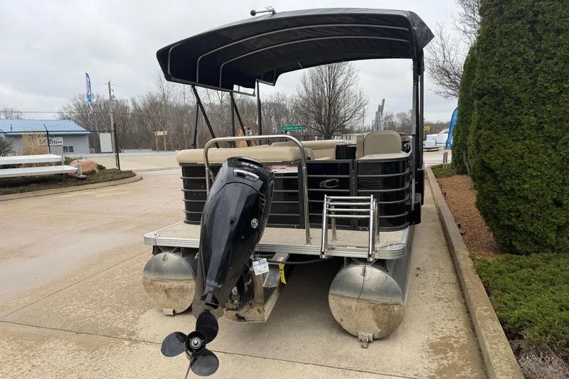 Slide: The Image of 2021 Crest Classic LX 200 L pontoon boat with outboard motor, parked outdoors. - 3