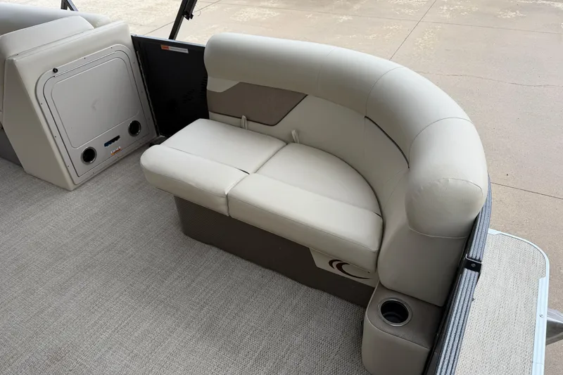 Slide: The Image of 2021 Crest Classic LX 200 L boat interior with beige seating and cup holder. - 5