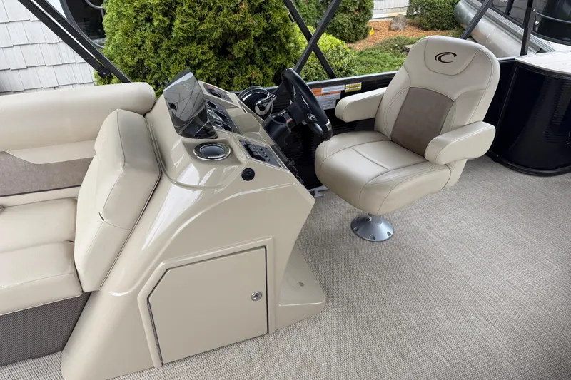 Slide: The Image of 2021 Crest Classic LX 200 L boat interior with beige captain's chair and console. - 7