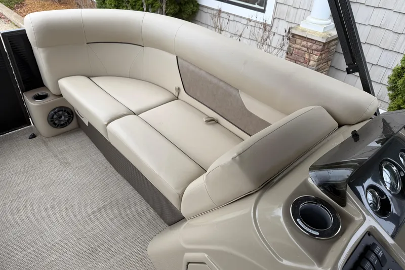 Slide: The Image of 2021 Crest Classic LX 200 L boat interior with beige seating and dashboard. - 8