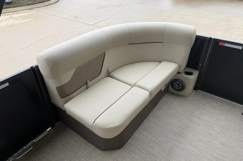 Slide: The Image of 2021 Crest Classic LX 200 L boat seating with beige upholstery and built-in speaker. - 9