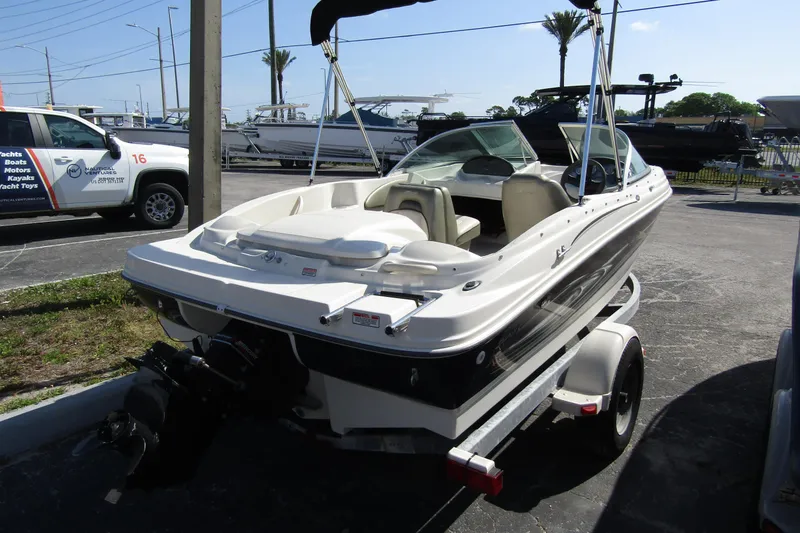 Slide: The Image of 2004 Sea Ray 180 Sport boat on trailer in outdoor lot. - 3