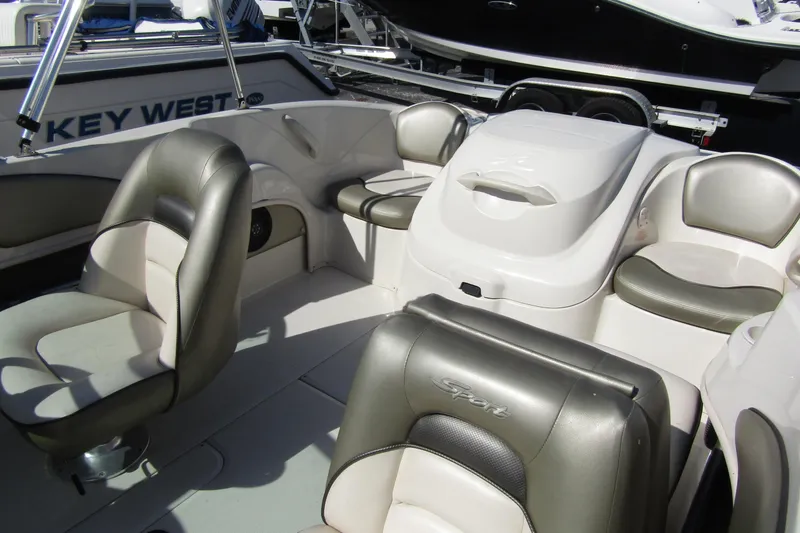 Slide: The Image of Interior of a 2004 Sea Ray 180 Sport boat with cushioned seating. - 6