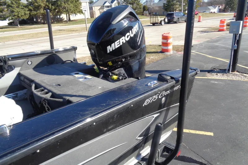 Slide: The Image of 2014 Lund 1875 Crossover XS boat with Mercury engine, parked outdoors. - 4