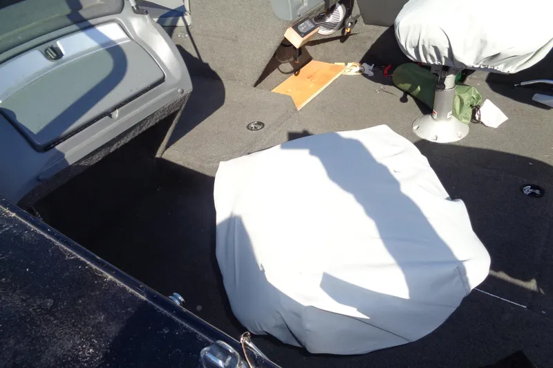 Slide: The Image of Interior of a 2014 Lund 1875 Crossover XS boat with covered equipment. - 8