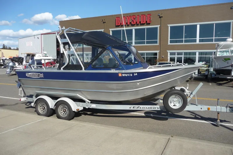 Slide: The Image of 2013 Thunder Jet 21 Luxor OB boat on trailer outside Bayside building. - 5