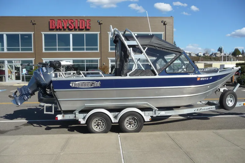 Slide: The Image of 2013 Thunder Jet 21 Luxor OB boat on trailer outside Bayside building. - 6