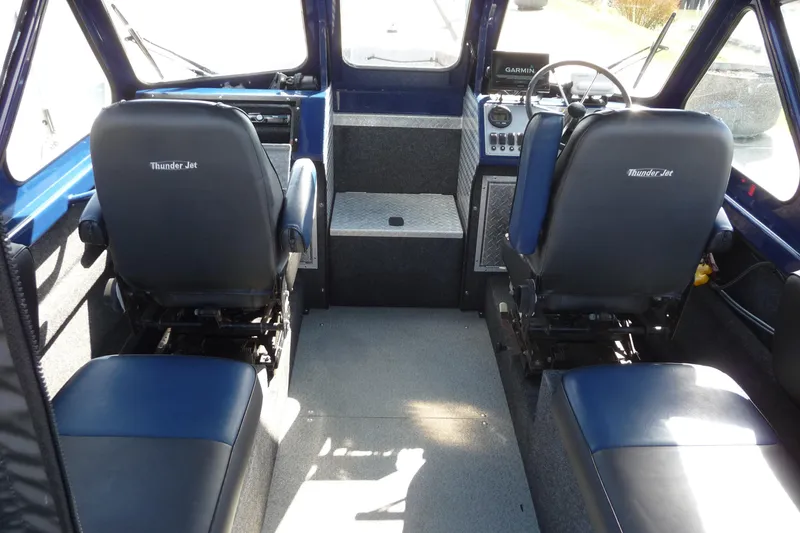 Slide: The Image of Interior of a 2013 Thunder Jet 21 Luxor OB boat with dual seating and control panel. - 7