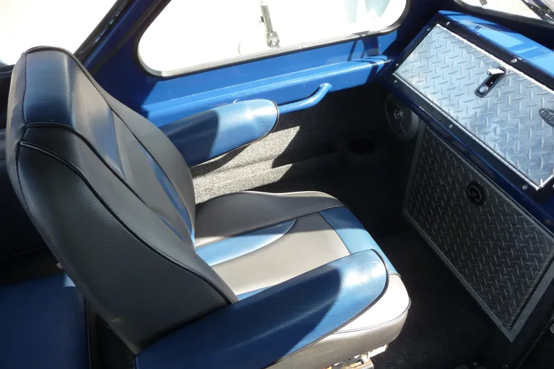 Slide: The Image of Interior of 2013 Thunder Jet 21 Luxor OB boat with blue and gray seating. - 9