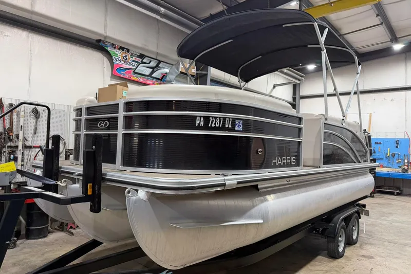 The Image of 2021 Harris Cruiser 210 pontoon boat in a workshop setting. - 0