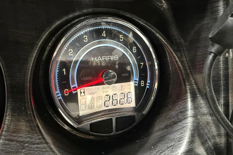 Slide: The Image of Close-up of a 2021 Harris Cruiser 210 RPM gauge displaying various indicators. - 10