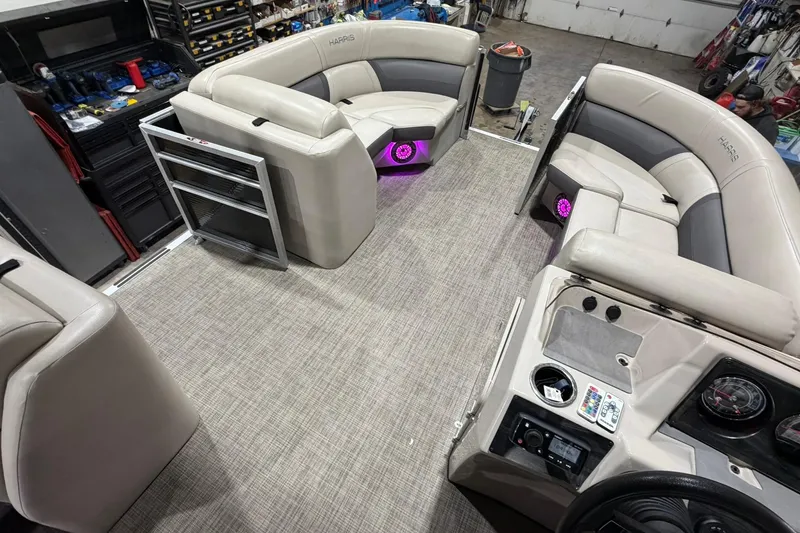 Slide: The Image of Interior of a 2021 Harris Cruiser 210 pontoon boat with beige seating and purple LED lights. - 11
