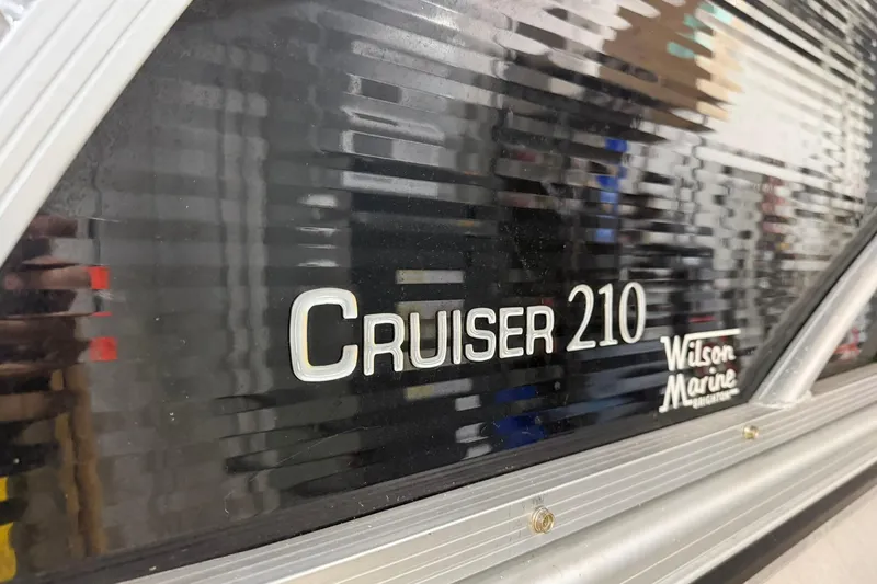 Slide: The Image of 2021 Harris Cruiser 210 boat logo with Wilson Marine branding. - 2