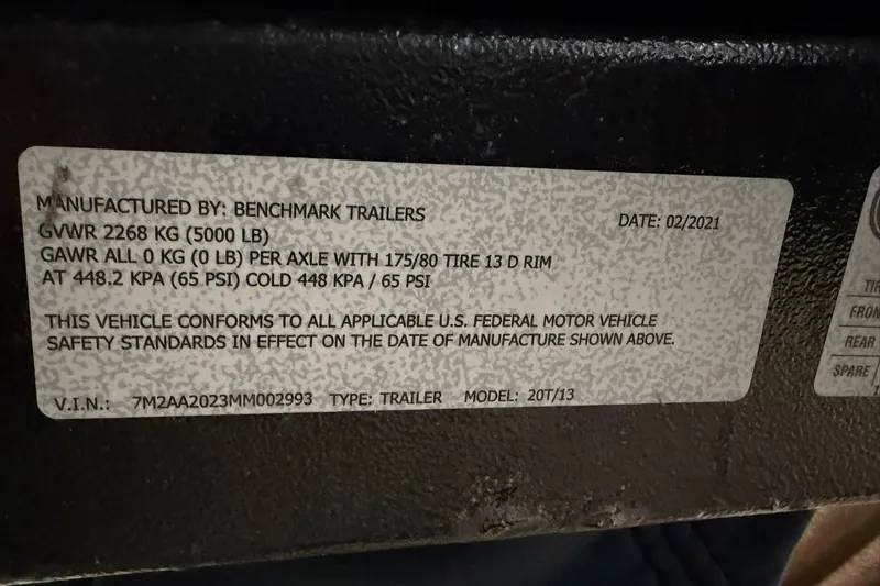 Slide: The Image of Label on a 2021 Harris Cruiser 210 trailer, detailing weight and safety standards. - 21