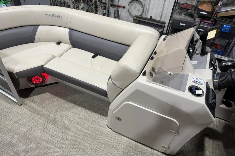 Slide: The Image of 2021 Harris Cruiser 210 boat interior with beige seating and control panel. - 5