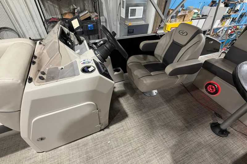 Slide: The Image of 2021 Harris Cruiser 210 boat interior with captain's chair and control panel. - 7